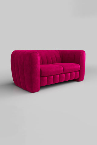 The Bowie Medium Sofa In Luxe Kneedlecord Velvet Harry's Pink on a plain background, seen from a side angle.