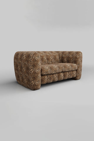 The Bowie Medium Sofa In Leopard Love Velvet Natural on a plain background, seen from a side angle.