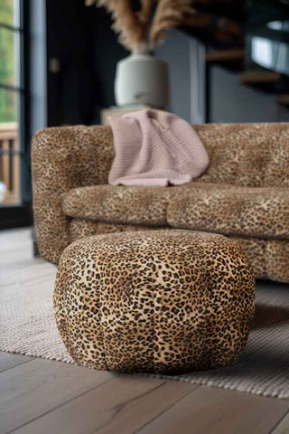 The Bowie Stool In Leopard Love Velvet Natural styled in front of a matching sofa in a living room.