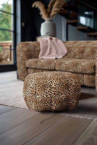 The Bowie Stool In Leopard Love Velvet Natural with the matching sofa in the background, styled in a living room.