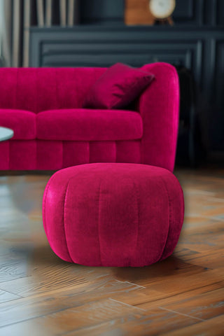 The Bowie Stool In Luxe Needlecord Velvet Harry's Pink styled in a living room with the matching sofa in the background.