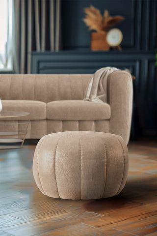 The Bowie Stool In Luxe Needlecord Velvet Natural Whisper styled in a living room with the matching sofa in the background.