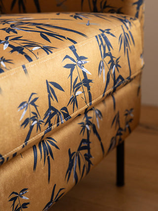 Detail shot of the front of the The Edie Bamboo & Golden Glow Velvet Armchair.