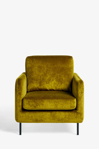 The Edie Needlecord Velvet Green Armchair in front of a plain background.