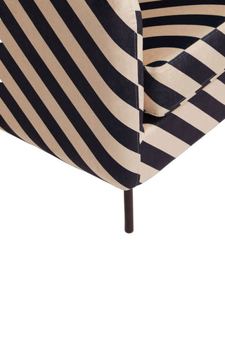 Detail shot of the corner/leg of the The Edie Sand and Black Stripe Armchair, on a white background.