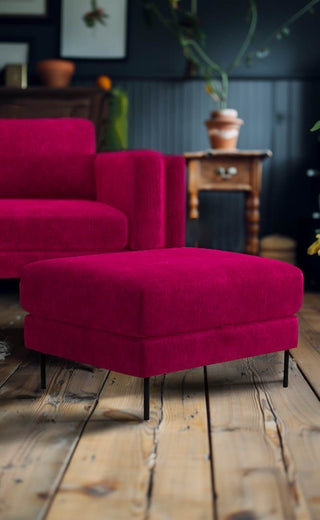 The Grace Foot Stool In Luxe Needlecord Velvet Harry's Pink styled in a living room in front of the matching sofa.