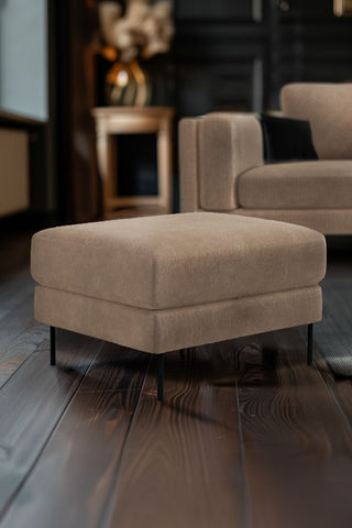 The Grace Foot Stool In Luxe Needlecord Velvet Natural Whisper in a living room with the matching sofa in the background.