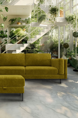 The Grace Large Sofa In Luxe Kneedlecord Velvet Vintage Green styled in a living room with a footstool.