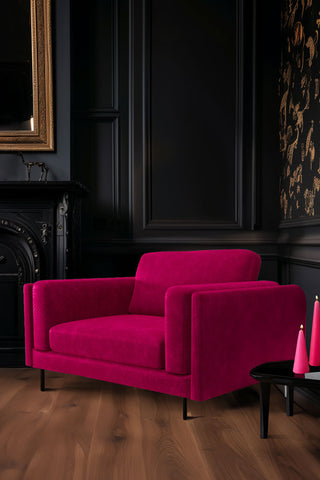 The Grace Love Seat In Luxe Kneedlecord Velvet Harry's Pink styled in the corner of a dark living room.