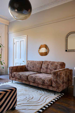 The Grace Medium Sofa In Leopard Love Velvet Natural styled in a living room.