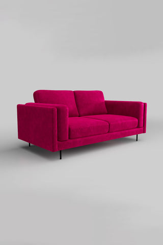 The Grace Medium Sofa In Luxe Kneedlecord Velvet Harrys Pink on a plain background, seen from a side angle.