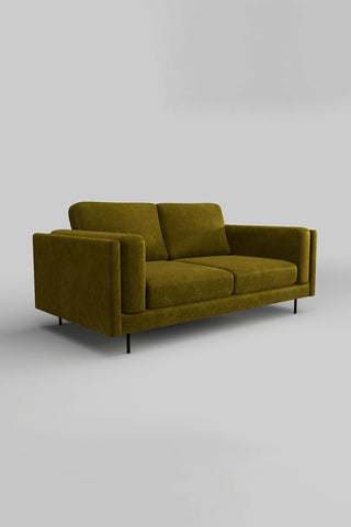 The Grace Medium Sofa In Luxe Kneedlecord Velvet Vintage Green on a plain background, seen from a side angle.