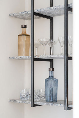 The Paveau - Gorgeous Ribbed Glass Carafe in Amber styled on a kitchen shelf with the blue version and various glassware.