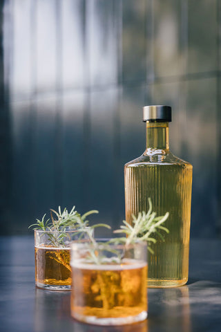 The Paveau - Gorgeous Ribbed Glass Carafe in Amber styled with two drinks.