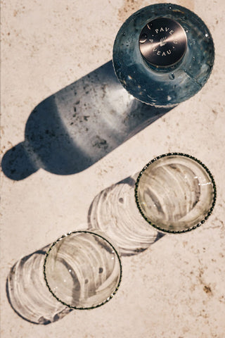 The Paveau - Gorgeous Ribbed Glass Carafe in Grey Blue seen from above with two glasses.