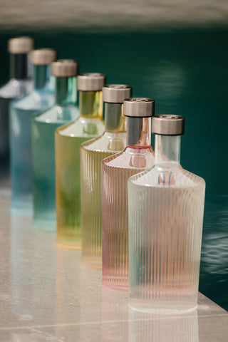 Various colours of the The Paveau - Gorgeous Ribbed Glass Carafe.