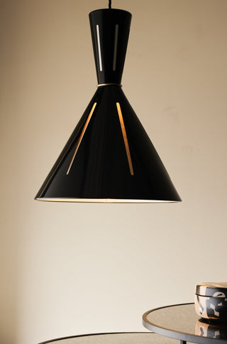 Lifestyle image of the Tribeca Metal Pendant Shade switched on over a nest of tables