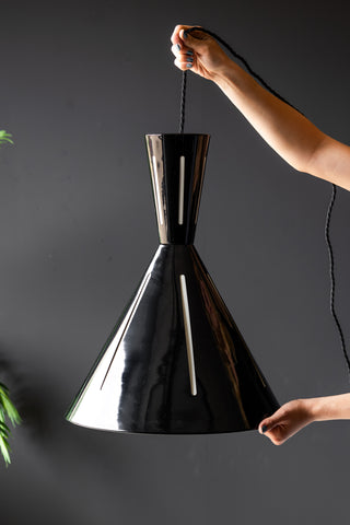 Tribeca Metal Pendant Shade being held against a dark background