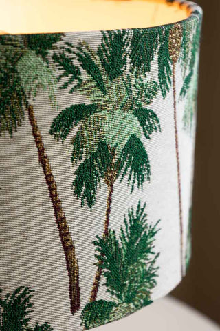 A close-up view of the fabric on the green palm tree table light.