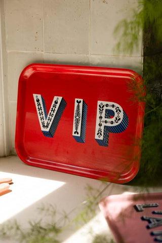The VIP Red Tray leaning against some kitchen tiles in the sun.
