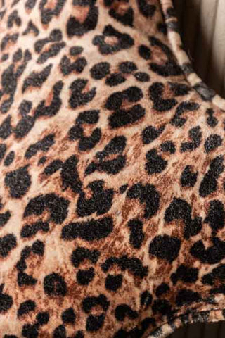 Close-up of the Velvet Star Cushion In Leopard Print.