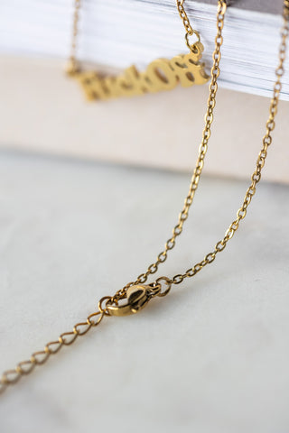 Close-up of the clasp and chain of the Waterproof Fuck Off Gold Necklace.