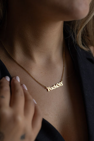 The Waterproof Fuck Off Gold Necklace styled on a model.