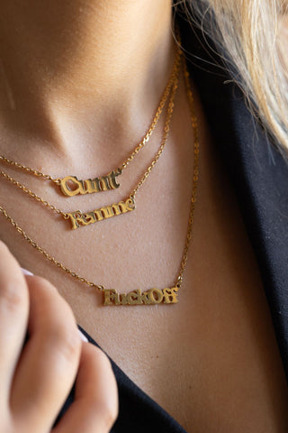 The Waterproof Fuck Off Gold Necklace styled with two others on a model.