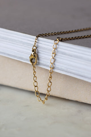 Close-up of the chain/clasp of the Waterproof Gold Cunt Necklace.