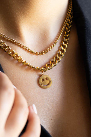 The Waterproof Wink Face Gold Duo-Chain Necklace styled on a model.