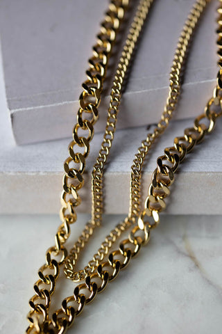 Close-up of the chains of the Waterproof Wink Face Gold Duo-Chain Necklace.