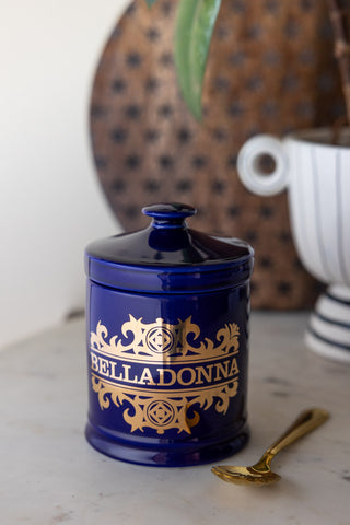 The What's Your Poison - Belladonna Jar styled on a counter with a spoon, plant and wooden serving board.