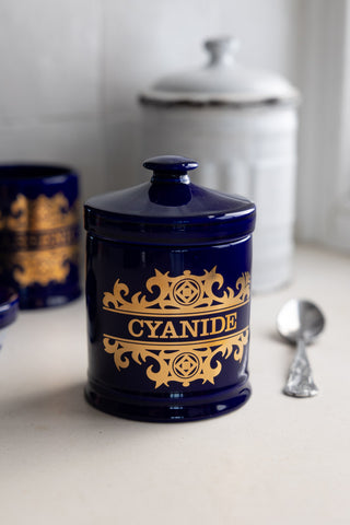 The What's Your Poison - Cyanide Jar styled on a white kitchen countertop against a white background.