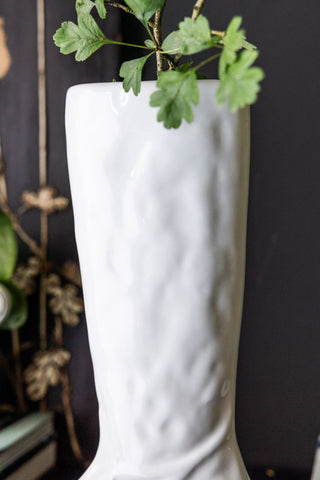 Close-up of the top of the Fabulous White Boot Vase with greenery inside.