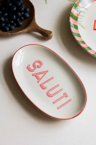 The White Saluti Plate styled with another plate and a wooden serving dish filled with blueberries.