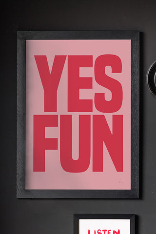 The Yes Fun Pink & Red Art Print - Unframed, styled in a frame on a black wall with other art prints and a mirror.