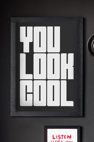 The You Look Cool Black & White Art Print - Unframed, styled in a black frame on a wall with another art print and a small mirror.