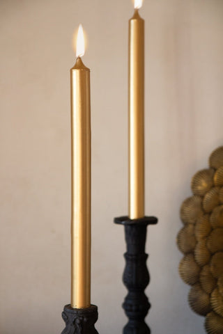 Image of 2 lit Metallic Gold Beautiful Dinner Candles in candle stick holders