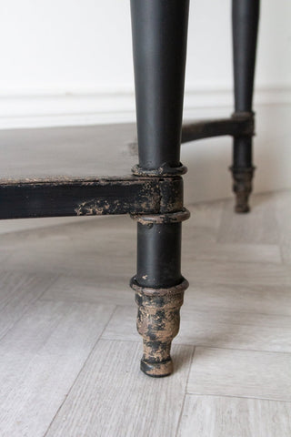 Close-up image of the legs & feet on the Black Vintage Style Metal Distressed Console Table With Drawer