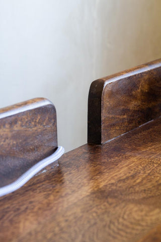 Close-up image of the cable gap on the Dark Mango Wood Desk