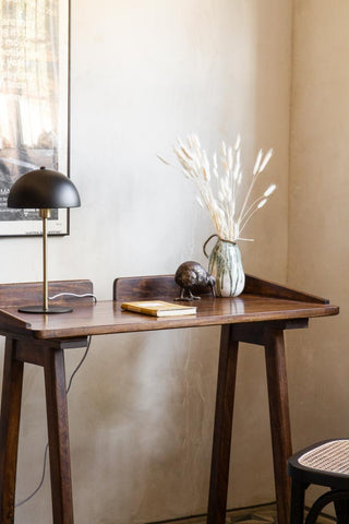 Close-up lifestyle image of the Dark Mango Wood Desk With Cable Gap