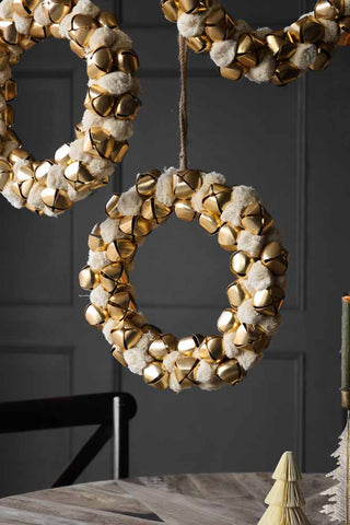 Lifestyle image of the Double-sided Ivory Bell Christmas Wreath over a tablescape