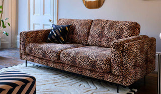 The Grace Medium Sofa In Leopard Love Velvet Natural styled in a living room.