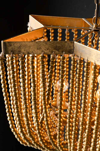 Detail shot of the metal frame and beads on the Gold Star Shaped Beaded Statement Chandelier Light.