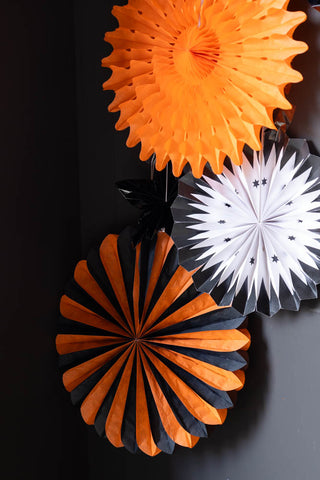 Orange pinwheel decorations styled against a dark background.