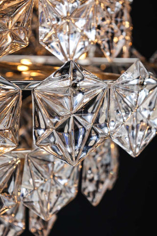 Close-up image of a glass disc on the Showstopping Multi-Layer Glass Chandelier lit up