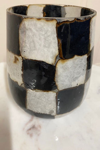 Black and white vase with cracks.