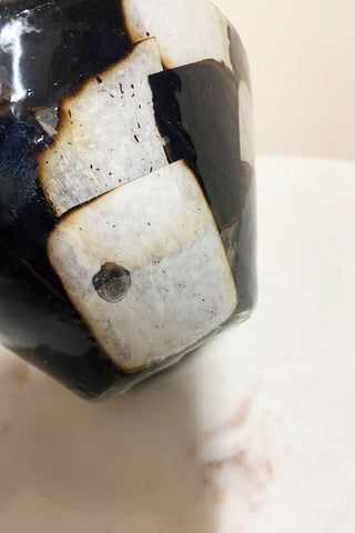 Side view of the black and white vase - a black blob.