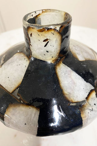 Top view of the cracks and damage to the black and white vase.