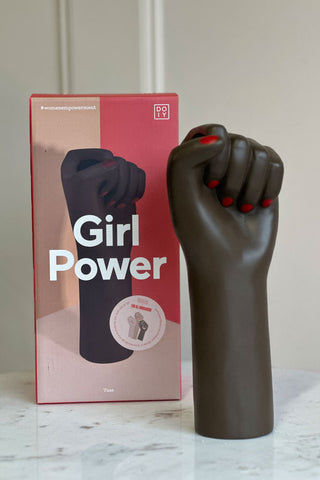 The girl power vase unboxed on a white marble table. In the background you can see the beautiful pink and red box.